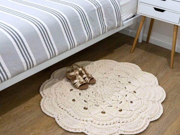 Crochet floor rug next to bed