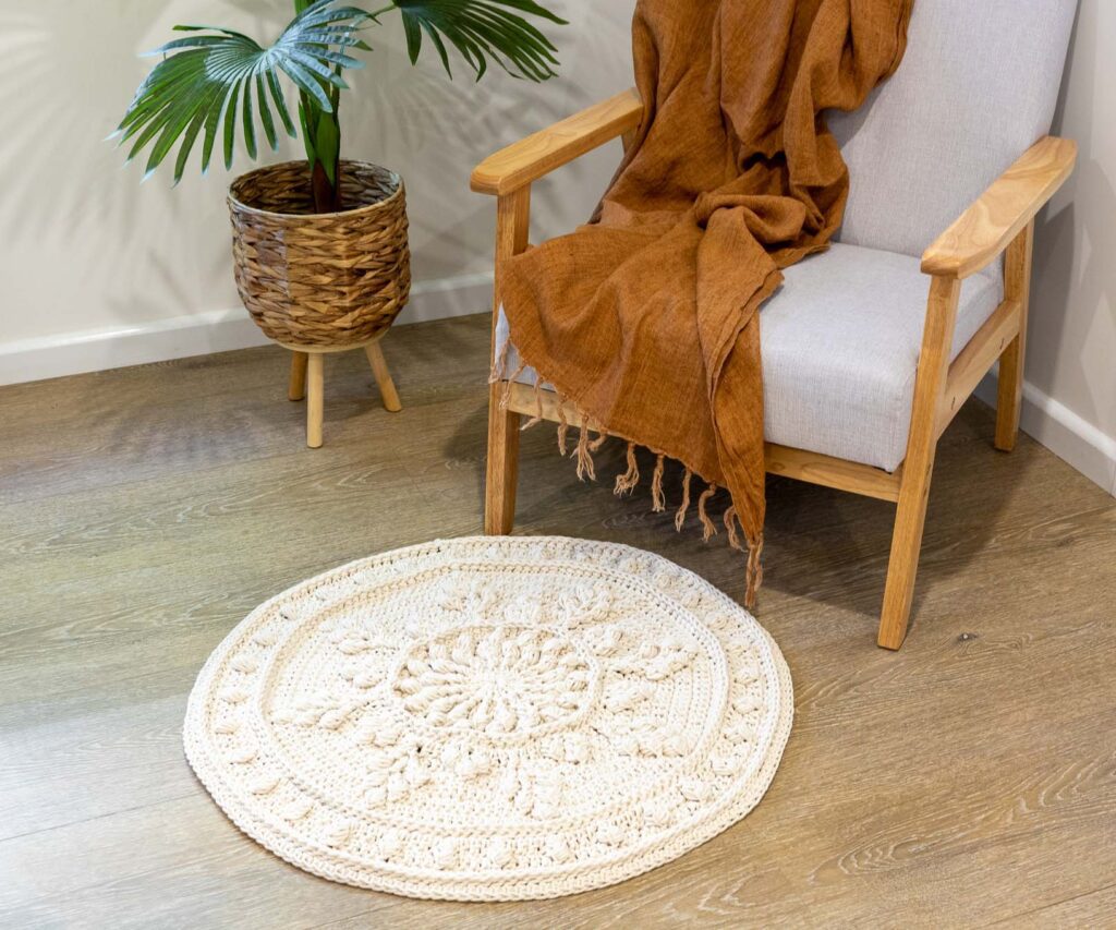 Oasis crochet floor rug in front of a chair.