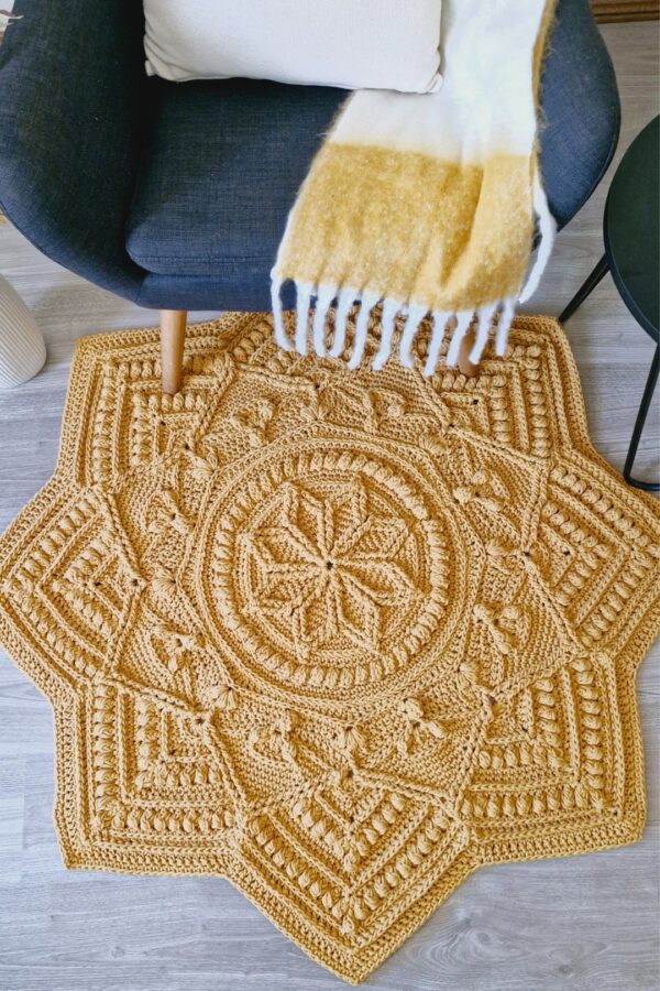 Crochet floor rug in front of chair.