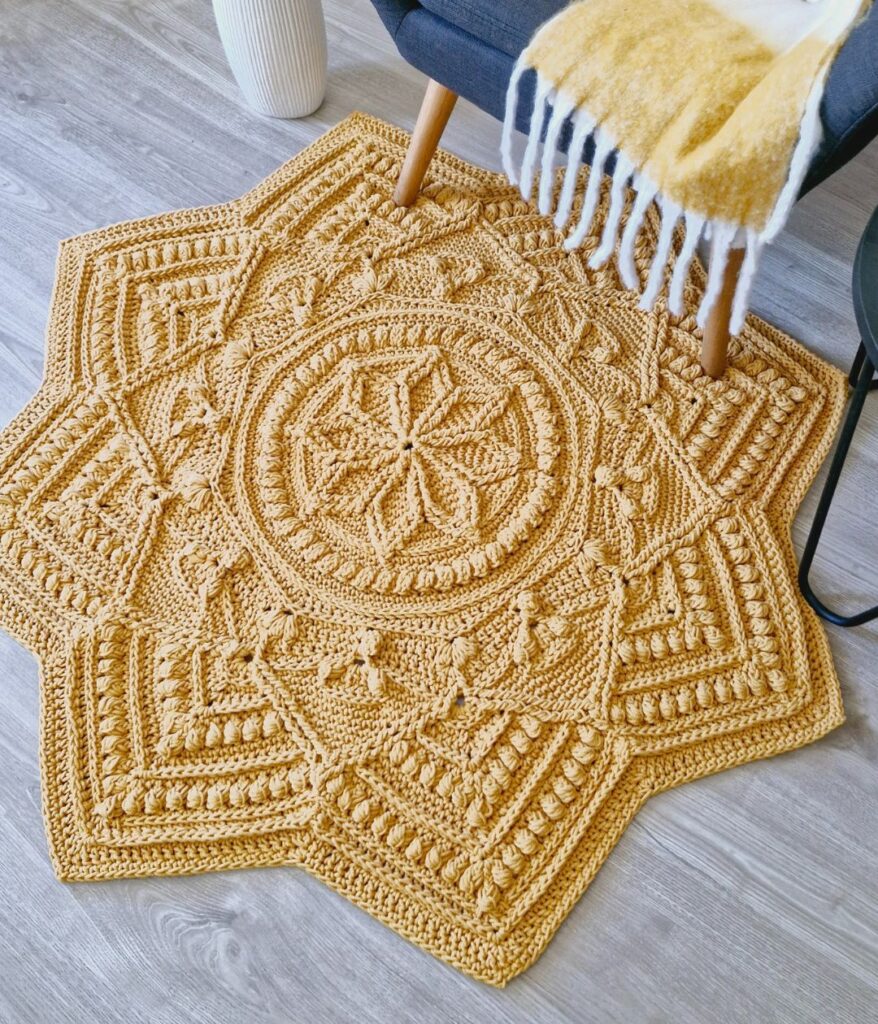 Crochet floor rug in front of chair.