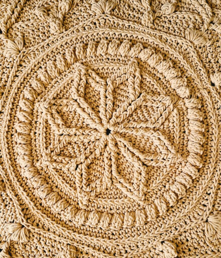 Close up of the centre of a crochet floor rug.