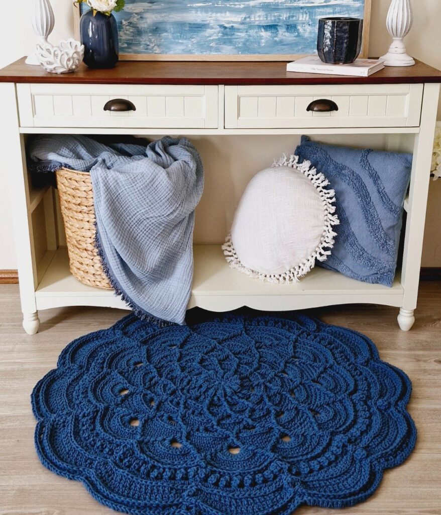 Dark blue crochet frug in front of hall table decorated with Hamptons-style decor.