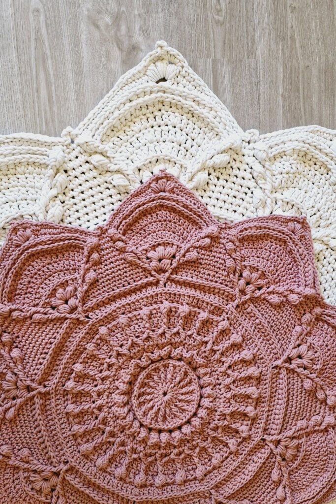 Cream and pink crochet floral floor rugs.