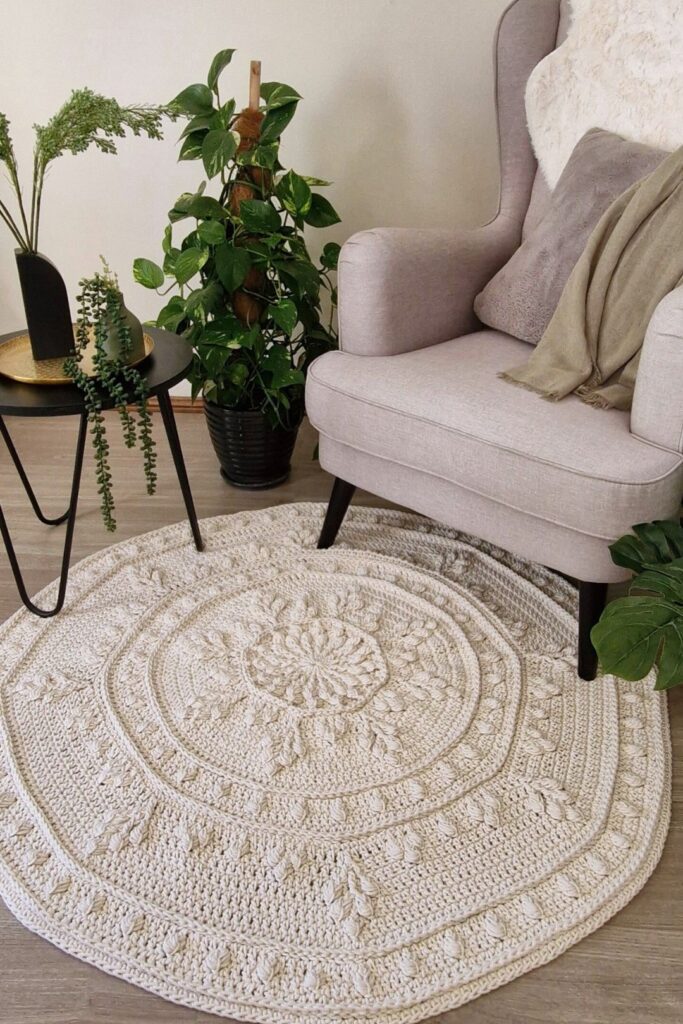Crochet floor rug in front of chair and coffee table.