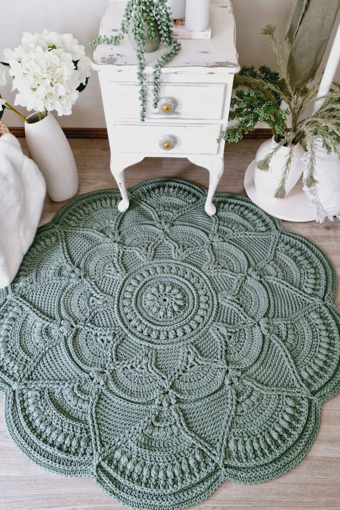 Crochet rug in front of table and flowers.